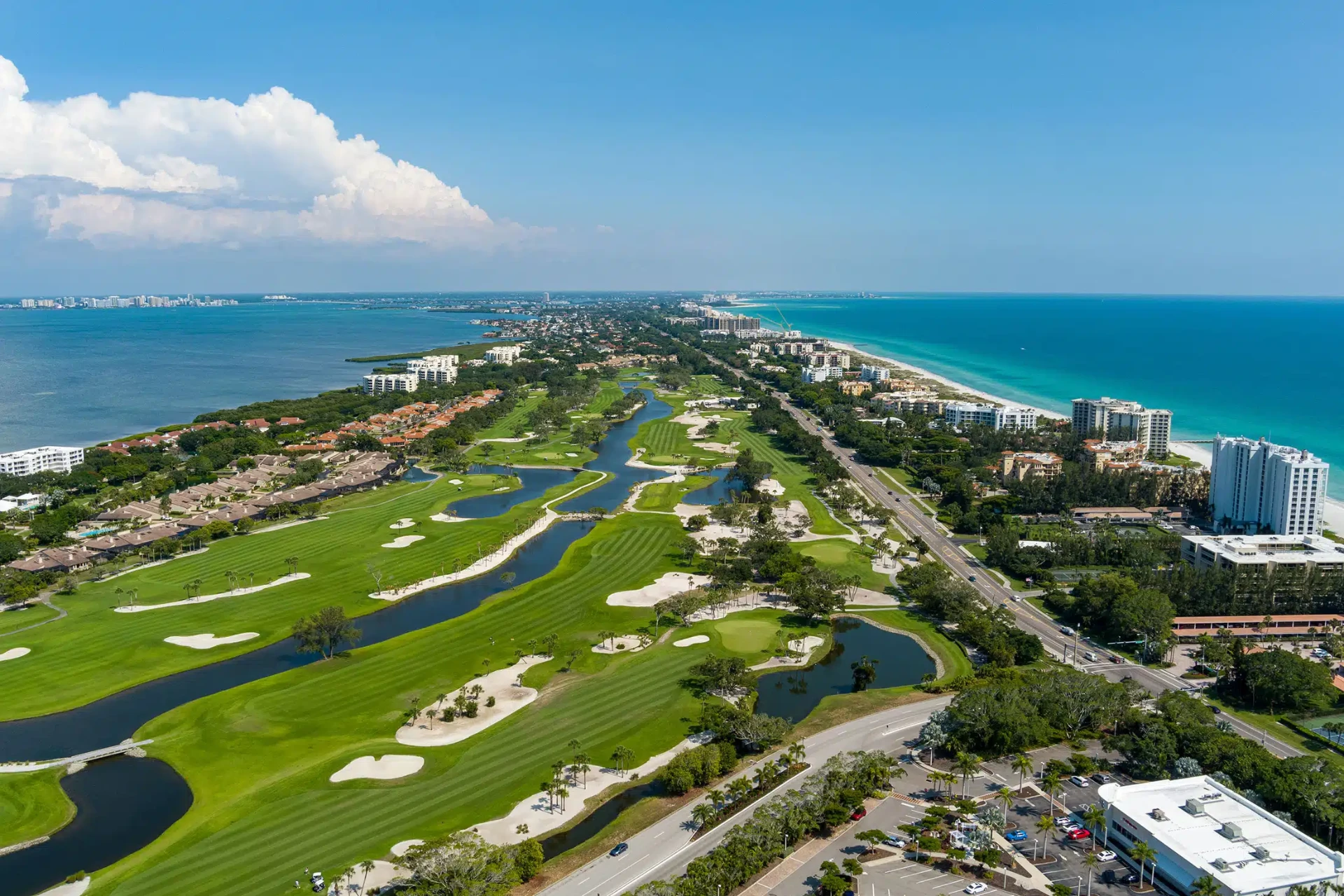 Aerial view of a Longboat Key golf community between Sarasota Bay and the Gulf beaches